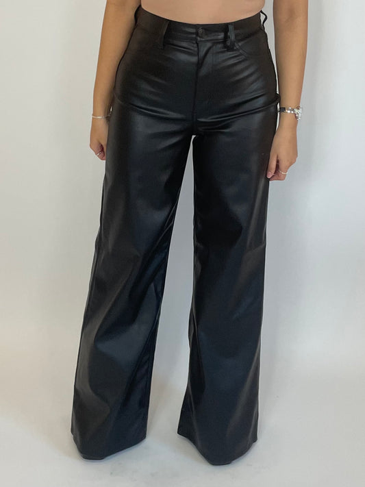 Black wide leg vegan leather pants are fitted at the waist and become wider at the thighs. Slight stretch to fit to your body perfectly! 